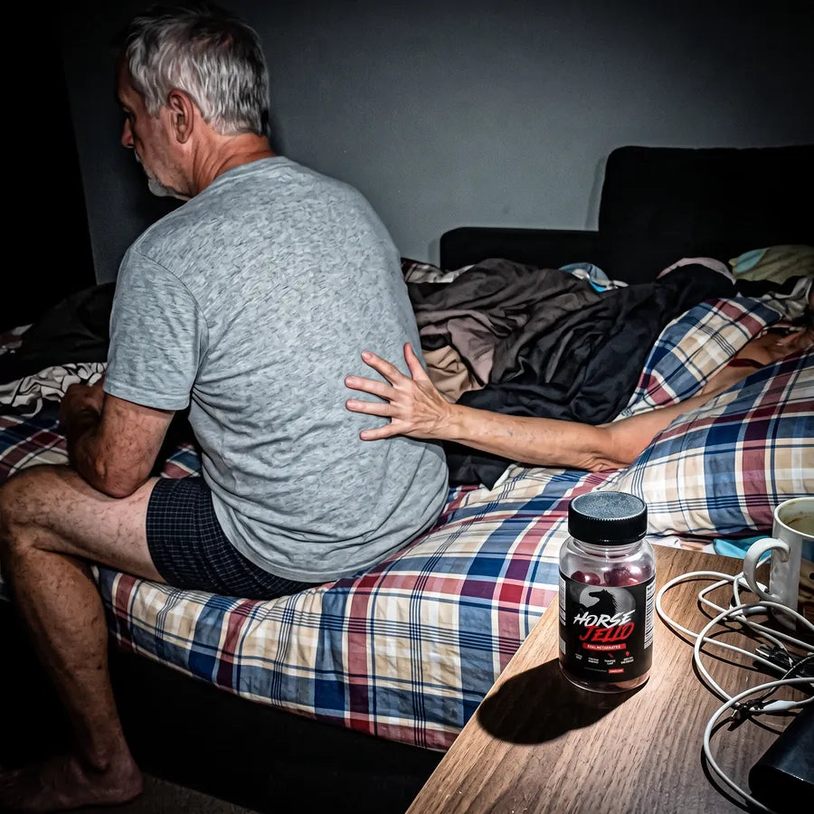 James K. on the edge of the bed, his wife reaching for him